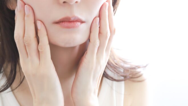 頬を押さえる女性